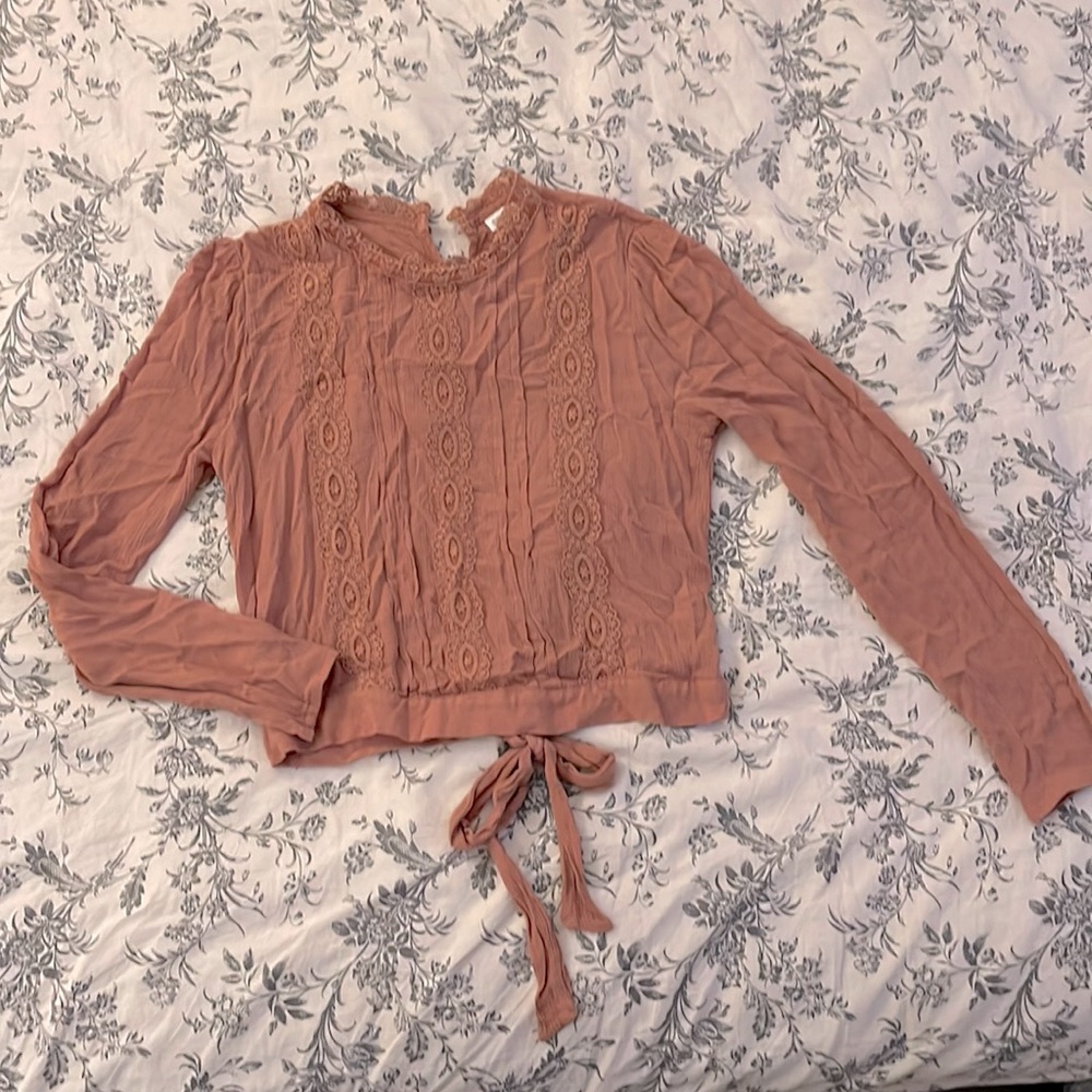 Tan long sleeve top with lace on the front and around neck.  size M
